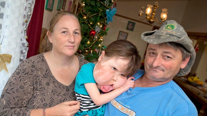 Katie with parents.JPG